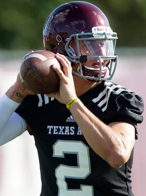 Texas A&M quarterback and Heisman Trophy winner Johnny Manziel throws during football practice on Aug. 5.