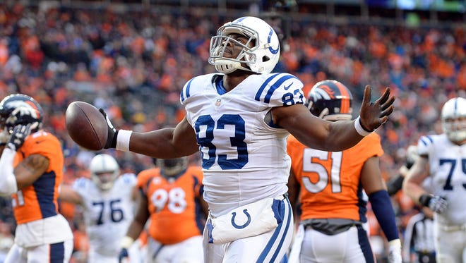 Indianapolis Colts tight end Dwayne Allen (83) celebrates after a touchdown against the Denver Broncos in the 2014 AFC Divisional playoff football game at Sports Authority Field at Mile High.