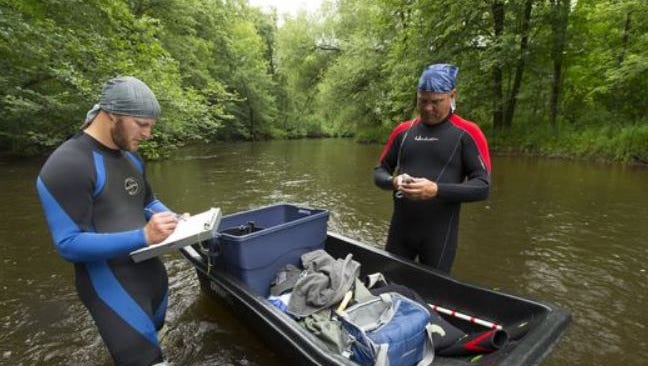 DNR staff conduct a survey for mussels in the Plover River near Stevens Point. A legislator wants to split the agency’s wildlife and environmental functions
