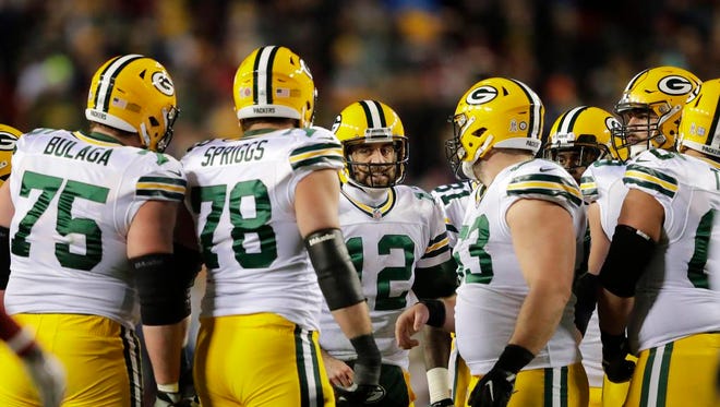 Green Bay Packers quarterback Aaron Rodgers huddles up the team against Washington in the third quarter Sunday, November 20, 2016, at FedEx Field in Landover, Maryland.