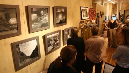 Participants in Art Walk Nyack look at photographs by Lisa Forman of Piermont on display at Hip Chik (cq) in Nyack June 15, 2007. The exhibit was part of . ( Peter Carr / The Journal News )