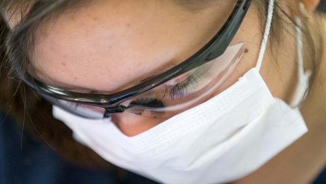 Ingrid Diaz learns how to do a dental exam on Monday, Feb. 2, 2015, at the J. Everett Light Career Center in Indianapolis. The Indiana Department of Workforce Development recently released its Hoosier Hot 50 jobs list and the Light Career Center trains people for a number of the top ones.