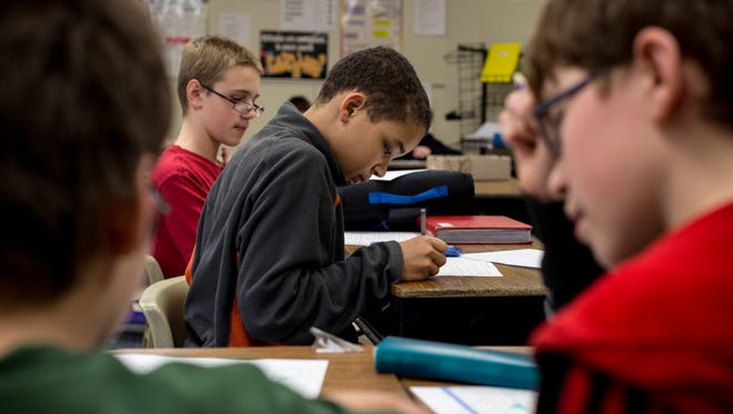 Seventh-grade student Brandon McGlothlin, 12, works on a problem during a math intervention class Wednesday, Feb. 3, 2016 at Holland Woods Middle School in Port Huron. Holland Woods has been removed from the state priority schools designation list.