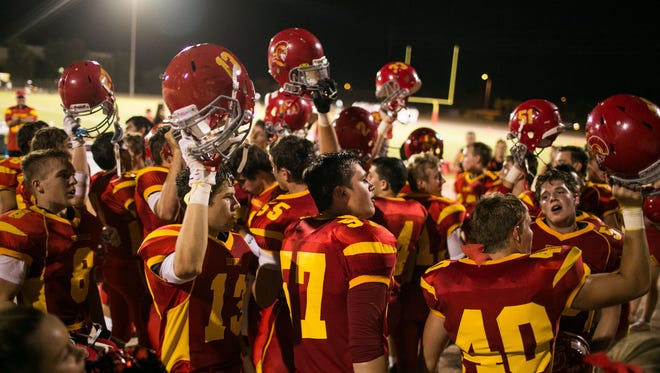 The Seton Catholic Sentinels celebrate the team's 35-24 home victory over the Estrella Foothills Wolves on Friday, Aug. 29, 2014, in Chandler, Ariz.