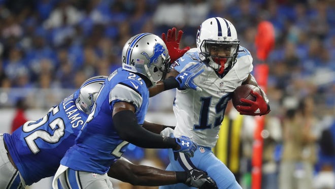 Lions linebacker Antwione Williams (52) and cornerback Nevin Lawson (24) chase Titans wide receiver Tajae Sharpe (19) during the first half Sunday.