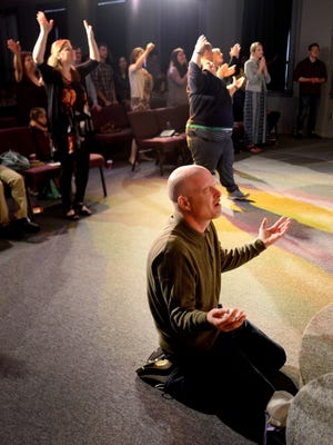 Keith Meadows kneels as the worship team sings during Easter service Sunday, April 5, at Connection Life Church in Salem.
