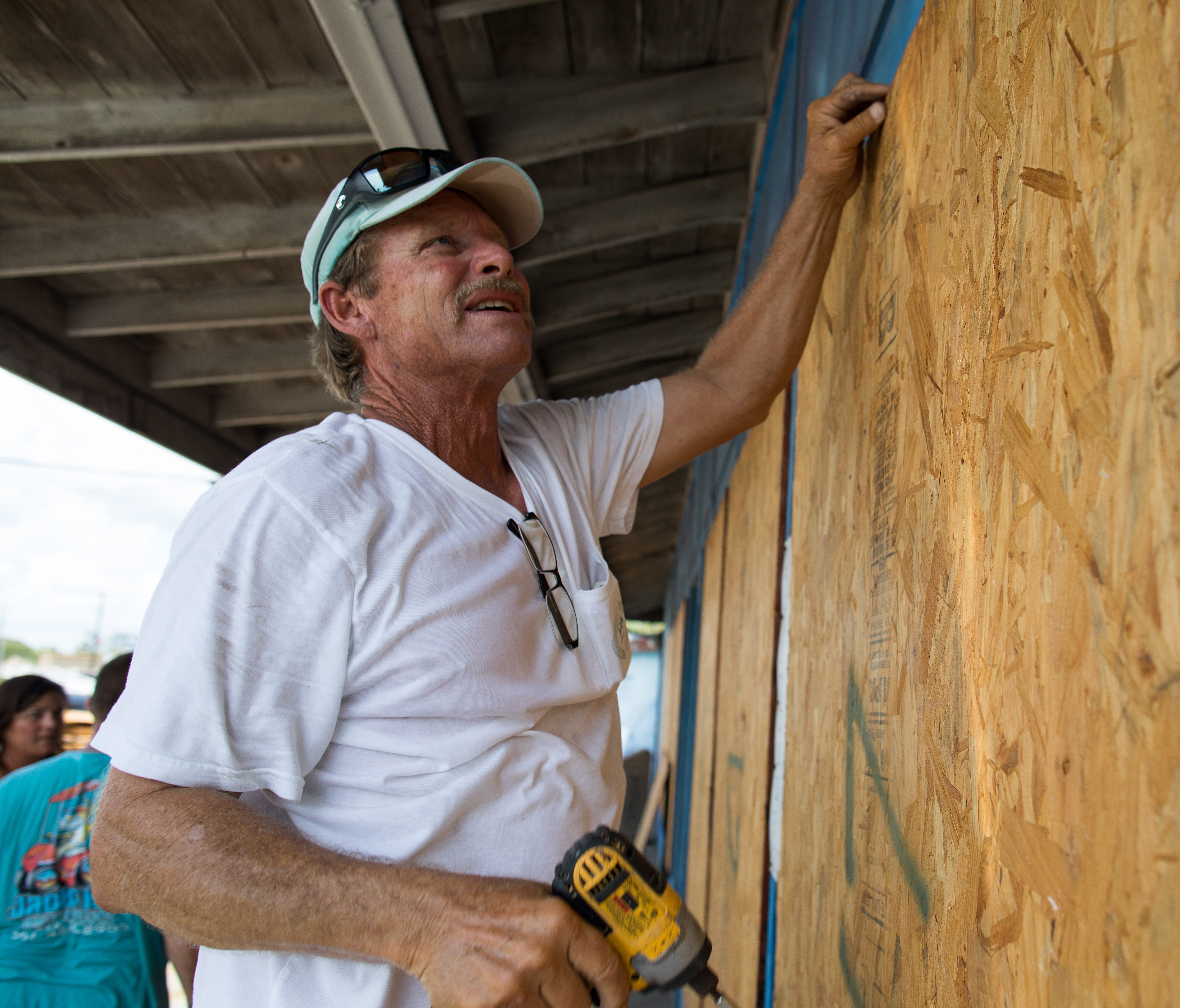 Mark Jones helps board up windows in Port Aransas ahead of hurricane Harvey on Aug. 24, 2017.