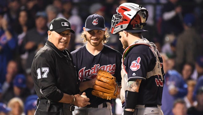 Oct 28, 2016; Chicago, IL, USA; MLB umpire John Hirschbeck (17) talks to Cleveland Indians starting pitcher Josh Tomlin (center) and catcher Roberto Perez (right) during the third inning in game three of the 2016 World Series against the Chicago Cubs at Wrigley Field.