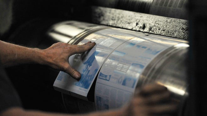 Printing plates are installed on a press ahead of a newspaper printing. Newspapers are the conscience of communities, writes columnist Marianne Heimes.