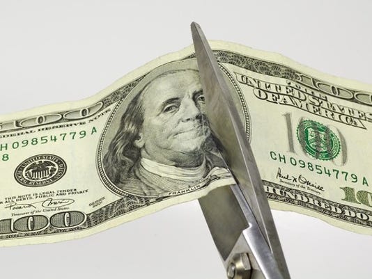 Smart Ways To Save Money In 2019 Without Cutting Amazon Prime Trips - cut spending scissors cash budget getty large jpg