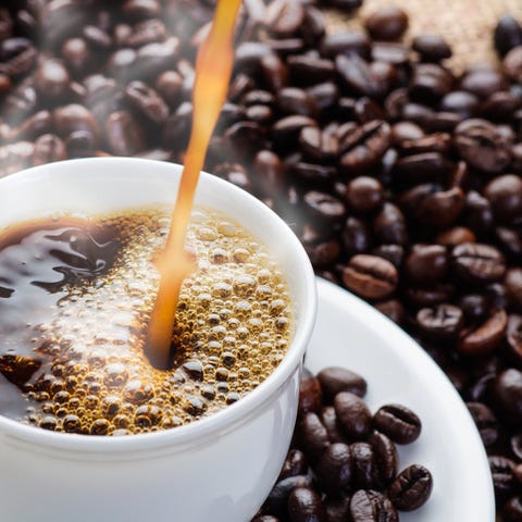 Close-up of steaming coffee being poured into a wh