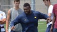 Michigan defensive lineman Maurice Hurst kicks a ball