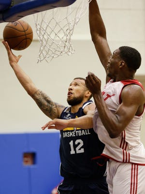 In this Monday, July 3, 2017 photo, Trey McKinney-Jones (12) of the Indiana Pacers takes a shot against Miami Heat's Bam Adebayo during the first half of an NBA summer league basketball game in Orlando, Fla. McKinney-Jones, a South Milwaukee graduate, has signed a 10-day contract with the Pacers.
