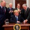 WASHINGTON -- President Donald Trump looks at an astronaut toy alongside former Senator and Apollo 17 Astronaut Jack Schmitt (2nd R), and NASA Astronaut Peggy Whitson (R) after a signing ceremony for Space Policy Directive 1, with the aim of returning Americans to the Moon, in the Roosevelt Room at the White House.