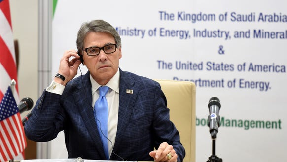 Energy Secretary Rick Perry listens during a signing
