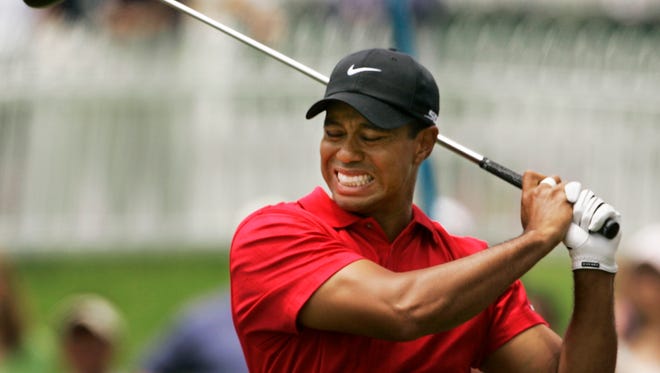 In this June 15, 2008 file photo, Tiger Woods grimaces after teeing off on the second hole during the fourth round of the US Open championship at Torrey Pines Golf Course in San Diego.
