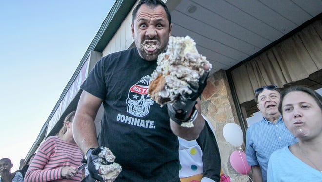 Contestant Monty "Moe train" Wiradilag celebrates after winning Cannon's Bakery inaugural eclair eating contest in September 2017. He just placed fifth at the Wing Bowl in Philadelphia