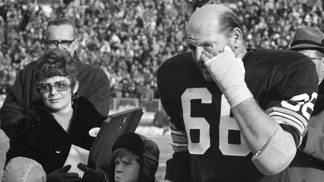 Surrounded by Jackie Nitschke and other family members, Ray Nitschke wipes away a tear as he receives an ovation from Packers fans at Lambeau Field during Ray Nitschke Day festivities on Dec. 31, 1971.