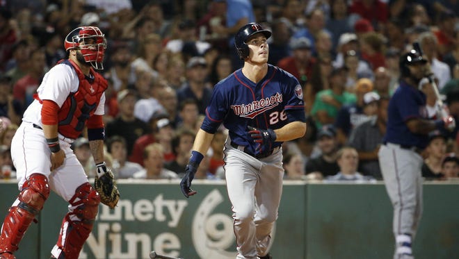The Minnesota Twins' Max Kepler (26) watches his RBI triple in front of the Boston Red Sox's Sandy Leon during the seventh inning Saturday in Boston.