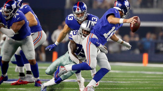 New York Giants quarterback Eli Manning (10) is sacked for a loss by Dallas Cowboys defensive back Kavon Frazier (35) during the first half of an NFL football game in Arlington, Texas, Sunday, Sept. 16, 2018. (AP Photo/Ron Jenkins)