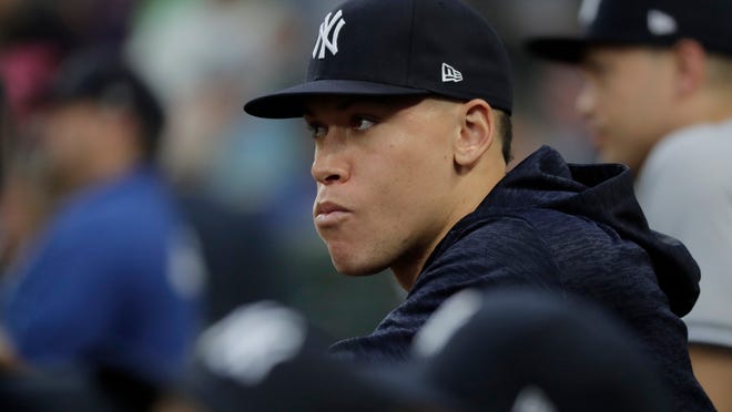Injured New York Yankees outfielder Aaron Judge watches from the dugout during the fourth inning of the team's baseball game against the Seattle Mariners, Saturday, Sept. 8, 2018, in Seattle. (AP Photo/Ted S. Warren)
