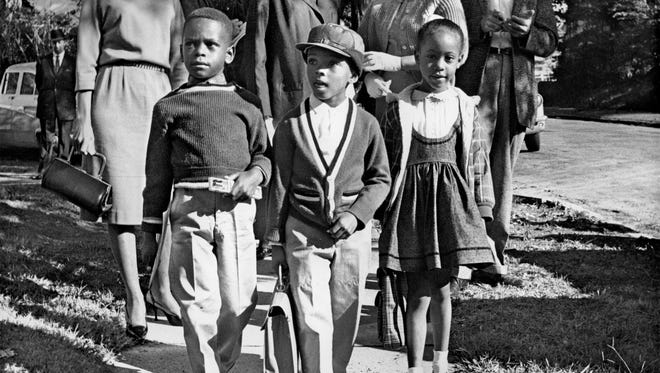 October 3, 1961 - Thirteen black first graders entered four of Memphis' previously all-white schools including Bruce School these students were attending. It marked the beginning of the Board of Education's "good faith" integration plan for the city's public school system. The children transferred to Bruce were from left; Harry Williams, 6, Michael Willis, 5, and Dwania Kyles, 5. Some 200 police guarded Bruce, Springdale, Rozelle and Gordon schools as school officials surprised the city with the first black first-graders that October morning. Willis, son of prominent black attorney A.W. Willis, later changed his name to Menelik Fombi.