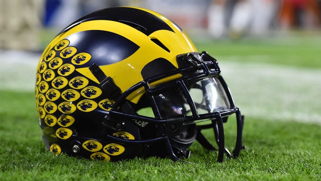 A Michigan Wolverines football helmet sits on the field prior to a game between the Florida State Seminoles and the Michigan Wolverines.