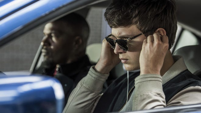 Ansel Elgort, right, and Jamie Foxx appear in a scene from “Baby Driver.”