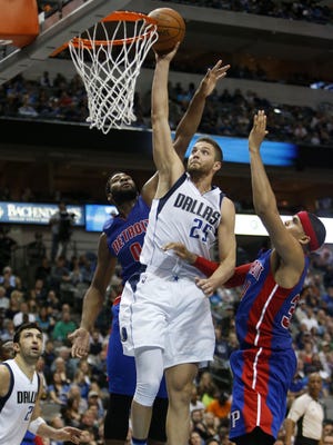 The Dallas Mavericks' Chandler Parsons goes up for a dunk against the Detroit Pistons' Andre Drummond, left, and Tobias Harris, right, on Wednesday, March 9, 2016, at the American Airlines Center in Dallas.
