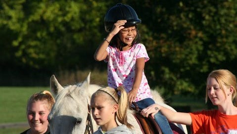 Jonalyn Cain (on horse) rides at LifeStriders, a therapeutic riding program in Waukesha. LifeStriders is one of the closest equine therapy programs to Milwaukee.