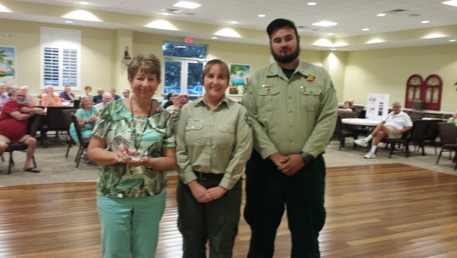 Kathy Thorton (left), Melissa Yunas, wildfire mitigation specialist with the Florida Forest Service, and Forest Ranger Ethan Brooks