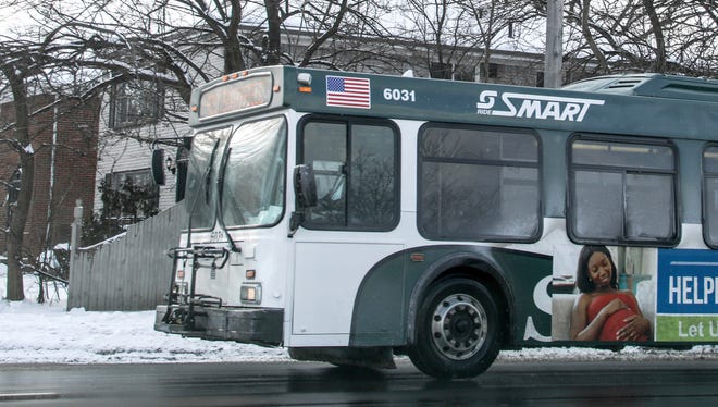 A SMART bus headed to Southfield drives down 8 mile road in Detroit in December 2017.