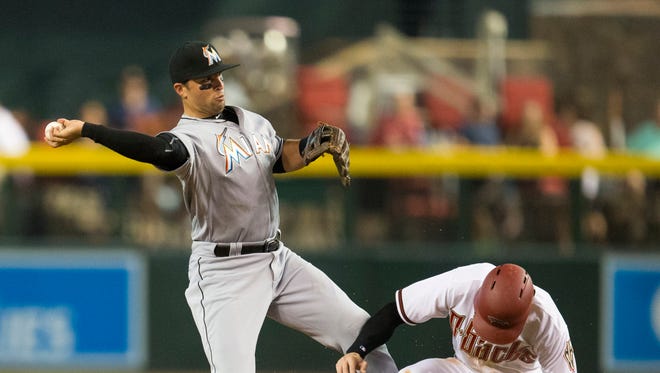 Miami Marlins second baseman Martin Prado throws to first for a double play after forcing out Arizona Diamondbacks' Ender Inciarte in the first inning at Chase Field July 20, 2015.