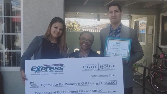 The Ventura County Express Employment Professionals staff presents a check for $1,850 to the nonprofit organization Lighthouse for Women and Children.