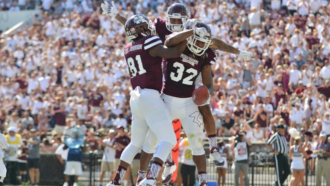 Mississippi State wide receiver Justin Johnson (81) and wide receiver Donald Gray (6) and running back Ashton Shumpert (32) celebrate after a touchdown by Shumpert  during the first quarter of the game against the Northwestern State Demons at Davis Wade Stadium. Mandatory Credit: Matt Bush-USA TODAY Sports