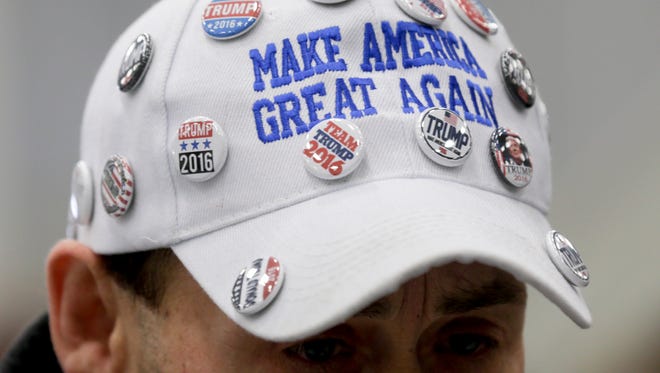 A supporter of Republican presidential candidate Donald Trump wears a hat with pins before a rally at Griffiss International Airport in Rome earlier in April.
