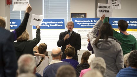 U.S. Rep. Tim Walberg, R-Mich., speaks as people...