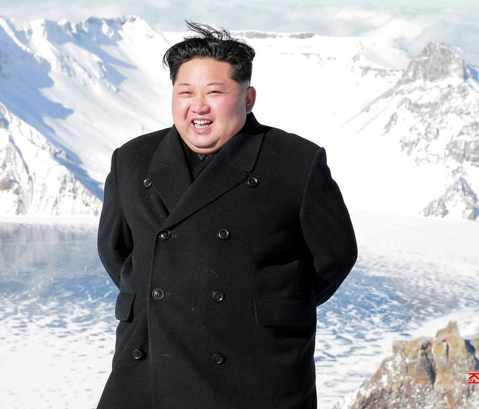 Kim Jong Un smiles after ascending North Korea's Mt. Paektu.