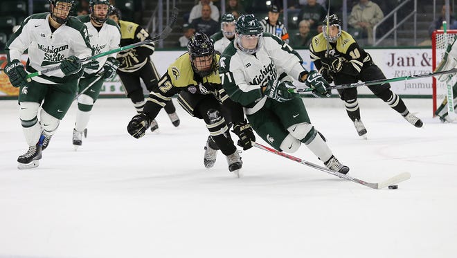 MSU's Logan Lambdin chases the puck during the Spartans' 6-4 win over Western Michigan Friday night at Munn Ice Arena.