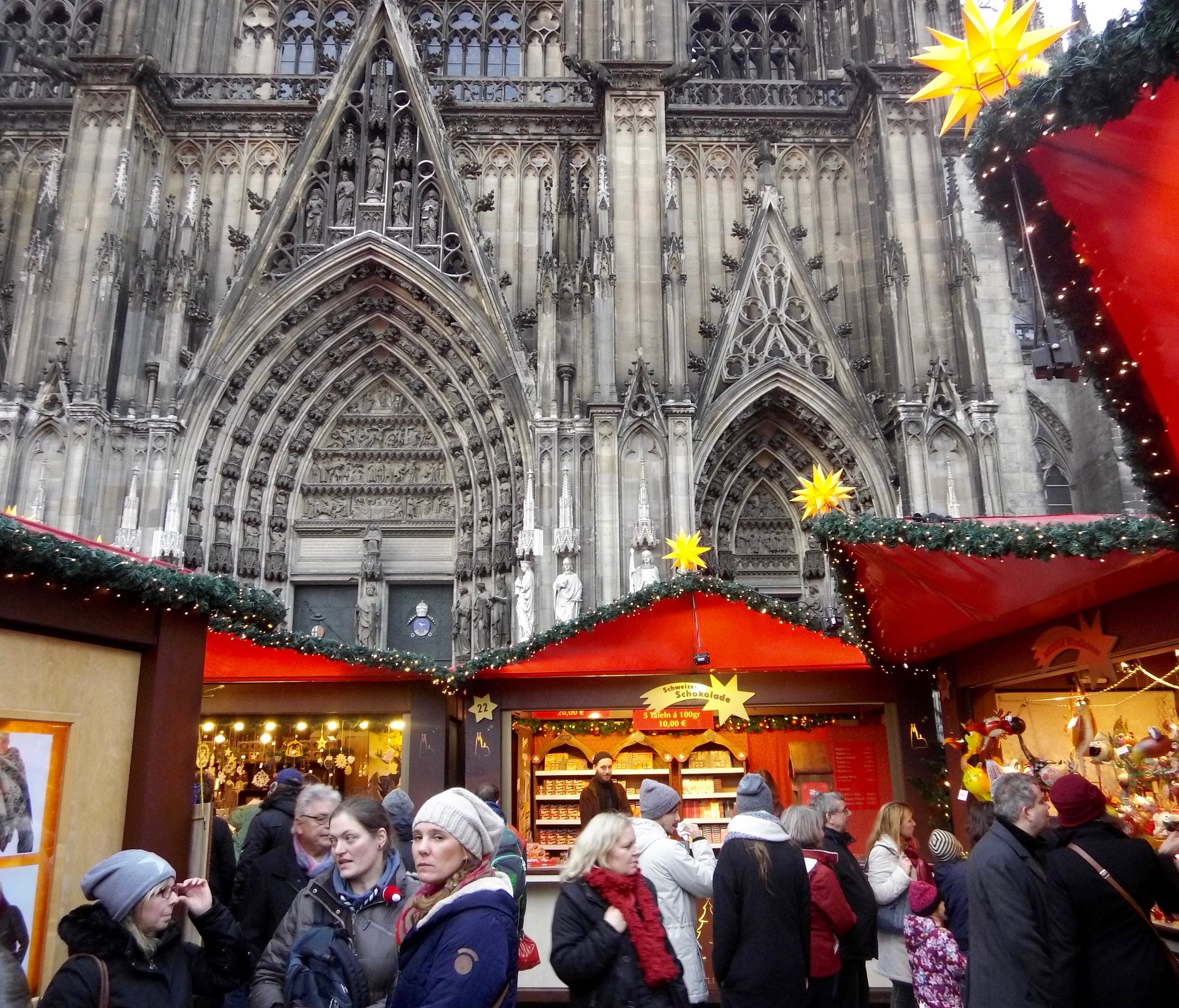 The Cologne Cathedral looms large at the Weihnachtsmarkt am Kölner Dom (Cathedral Christmas Market) in Cologne, Germany.