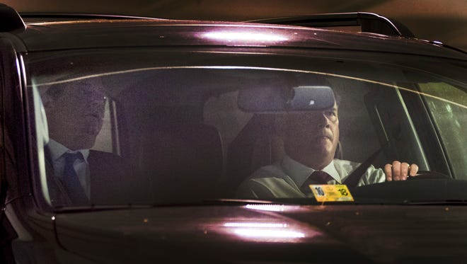 Former Trump campaign chairman Paul Manafort, left, leaves his home in Alexandria, Va., on Oct. 30, 2017. A federal grand jury has charged Manafort and his business and campaign associate Rick Gates with 12 counts — including conspiracy, money laundering, failing to register as foreign agents and making false statements.