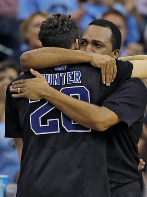 Georgia State head coach Ron Hunter hugs his son R.J. after taking him out of the game against Xavier during the second half of an NCAA tournament third round basketball game Saturday, March 21, 2015, in Jacksonville, Fla.  Xavier defeated Georgia State 75-67.