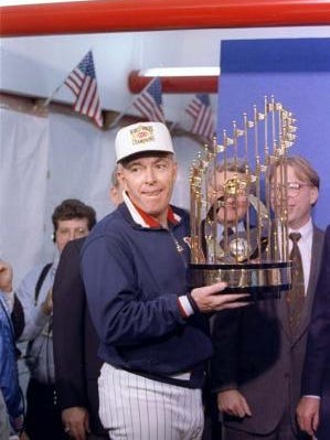 Twins manager Tom Kelly hoists the World Series championship trophy in 1991 after a 1-0 victory over Atlanta in 10 innings in Game 7.