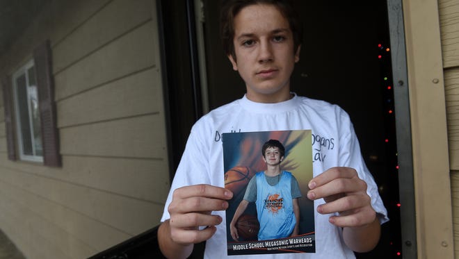 Devin Clark, older brother of Logan Clark, holds up a photo taken last summer of his brother at his home in Reno on Dec. 13, 2016.