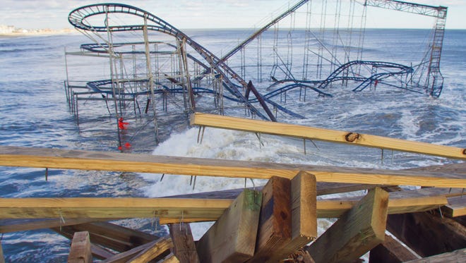 Seaside Heights - Pieces of broken pier lay at the edge of structure as Roller Coaster lays in the ocean waters below. Work moves slowly but at a steady pace on planning and repairing Casino Pier after Superstorm Sandy destroyed much of the pier. Peter Ackerman/Staff Photographer - 01/31/13 - piers130131a