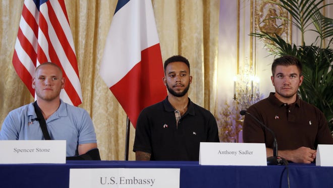 From left, U.S. Airman Spencer Stone, Anthony Sadler, a senior at Sacramento University in California, and U.S. National Guardsman from Roseburg, Oregon, Alek Skarlatos, attend a press conference with Jane D. Hartley, U.S. Ambassador to France, at the U.S. Ambassador's residence in Paris, France, Sunday, Aug. 23, 2015. Sadler, Skarlatos and Stone helped foil a potentially deadly attack when they subdued a man armed with an assault rifle and other weapons on board a high-speed train bound for Paris two days ago. The man was known to intelligence services in three countries and had ties to radical Islam, authorities said Sunday. (AP Photo/Francois Mori)