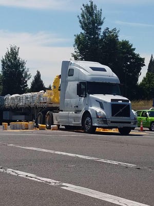 A semi-truck spilled several gallons of yellow paint on Salem Parkway around 2 p.m. Wednesday.