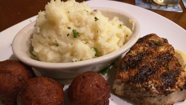 The Green Marlin's blackened swordfish. Each entrée comes with two sides. Pictured are mashed potatoes and hush puppies.