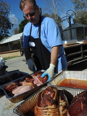 Volunteer Tom Resler cooks hams as the Camarillo Moose Lodge 2047 Chapter 1957 served over 800 dinners prepared from over 70 turkeys and more than 20 hams.