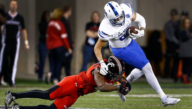 University of Memphis tight end Daniel Montiel (right) is brought down by University of Cincinnati defender Zach Edwards (left) during first quarter action in Cincinnati, Ohio. 